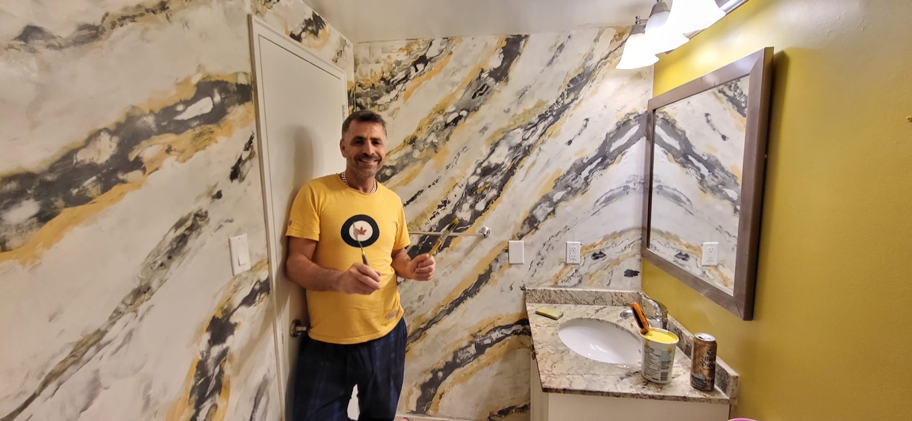 The craftsman beside a completed feature wall